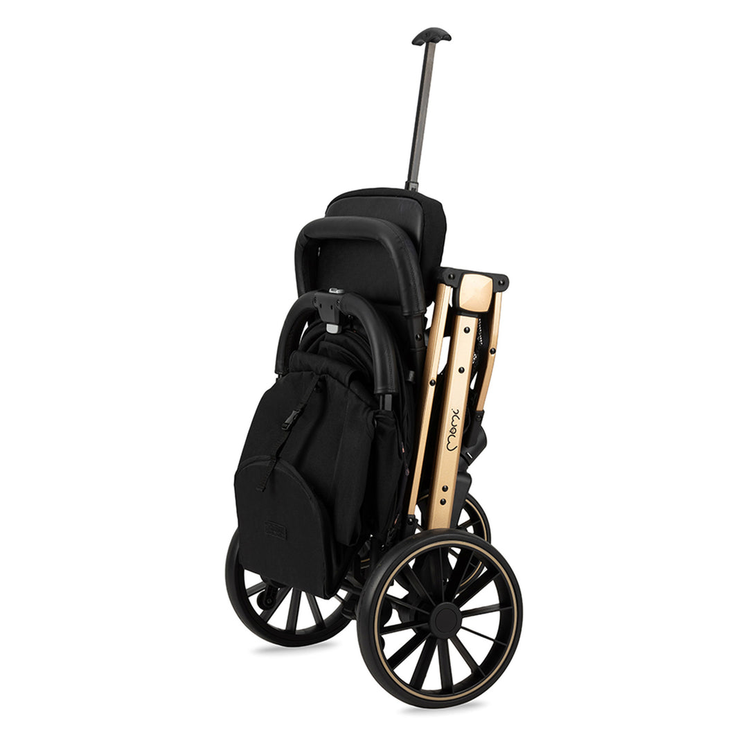 Momi folded black and gold stroller