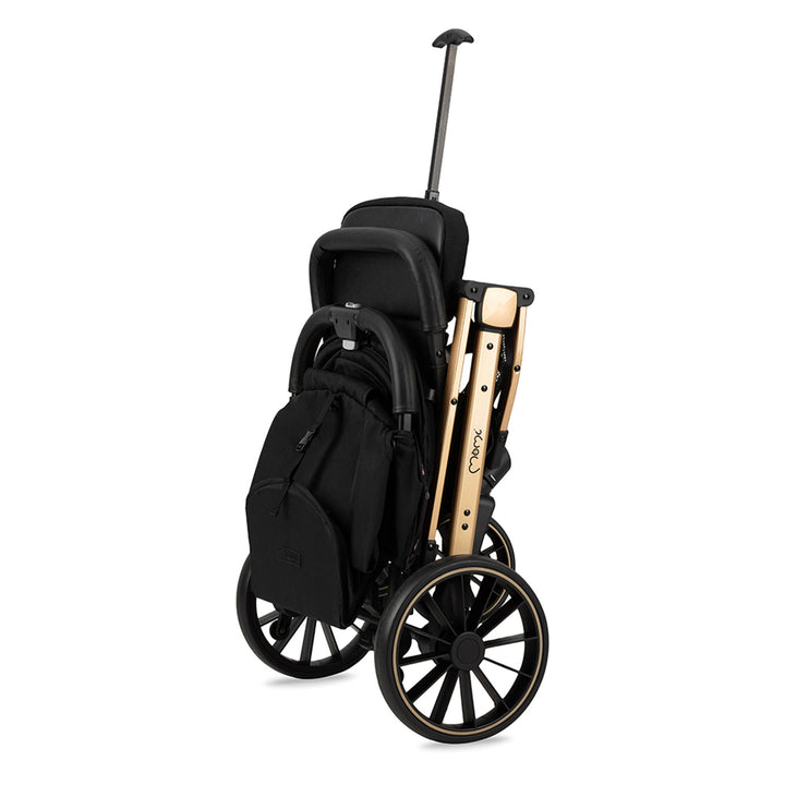 Momi folded black and gold stroller