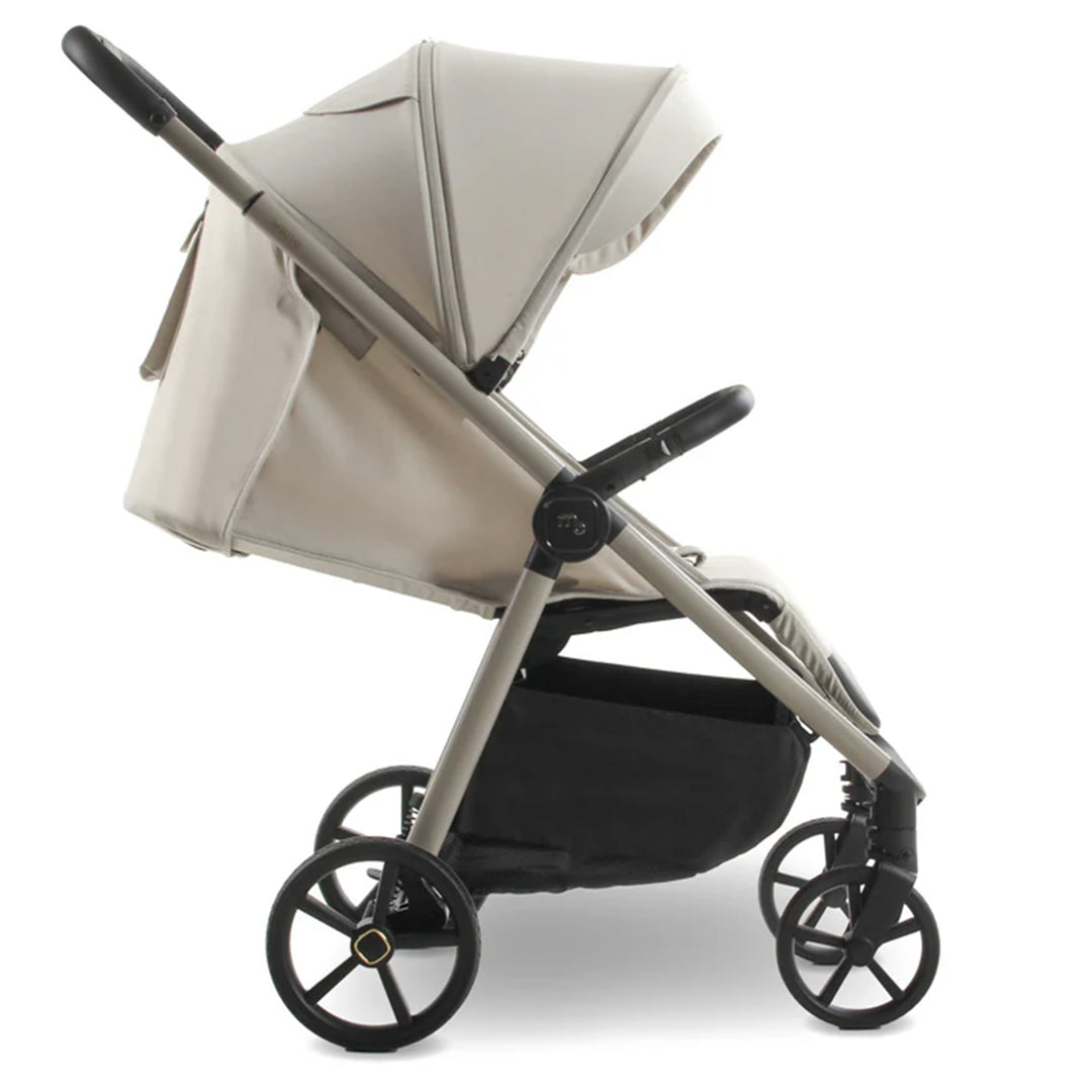 Beige stroller with a black base on a white background