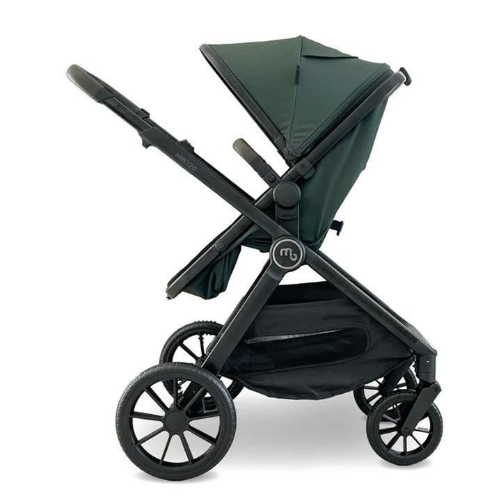 Green and black stroller on a white background