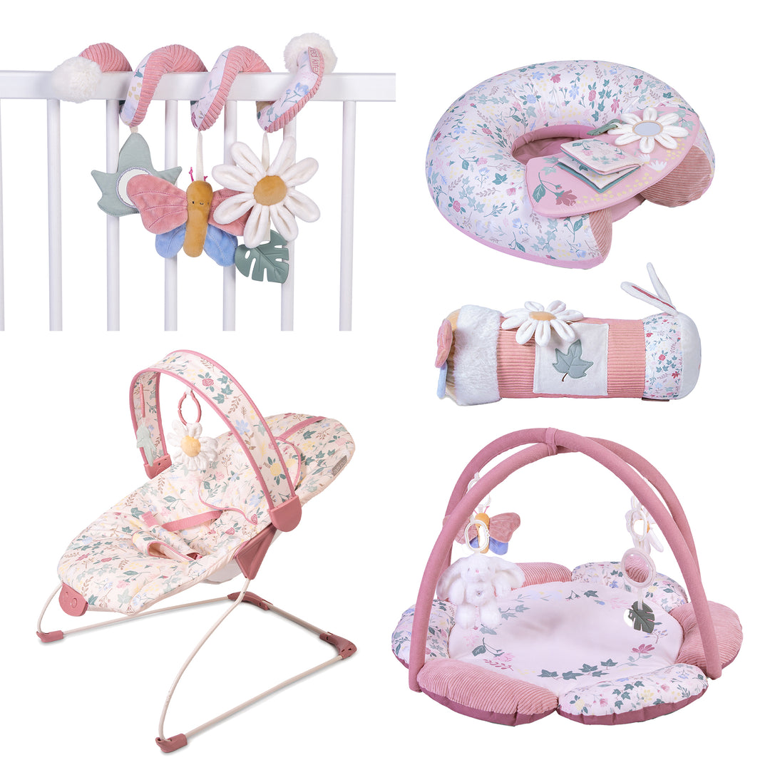 A collection of baby activity toys including a play gym with hanging toys, a pink bouncer chair, a spiral toy attachment, and a tummy time roller, all featuring a floral and butterfly pattern.