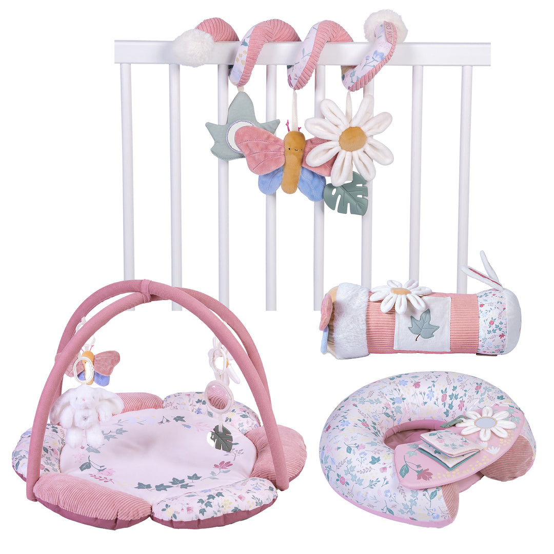 A collection of baby play gym and activity toys including a padded play gym with hanging toys, a sit-me-up chair with a detachable play tray, and a spiral toy bar with colorful patterns and textures.
