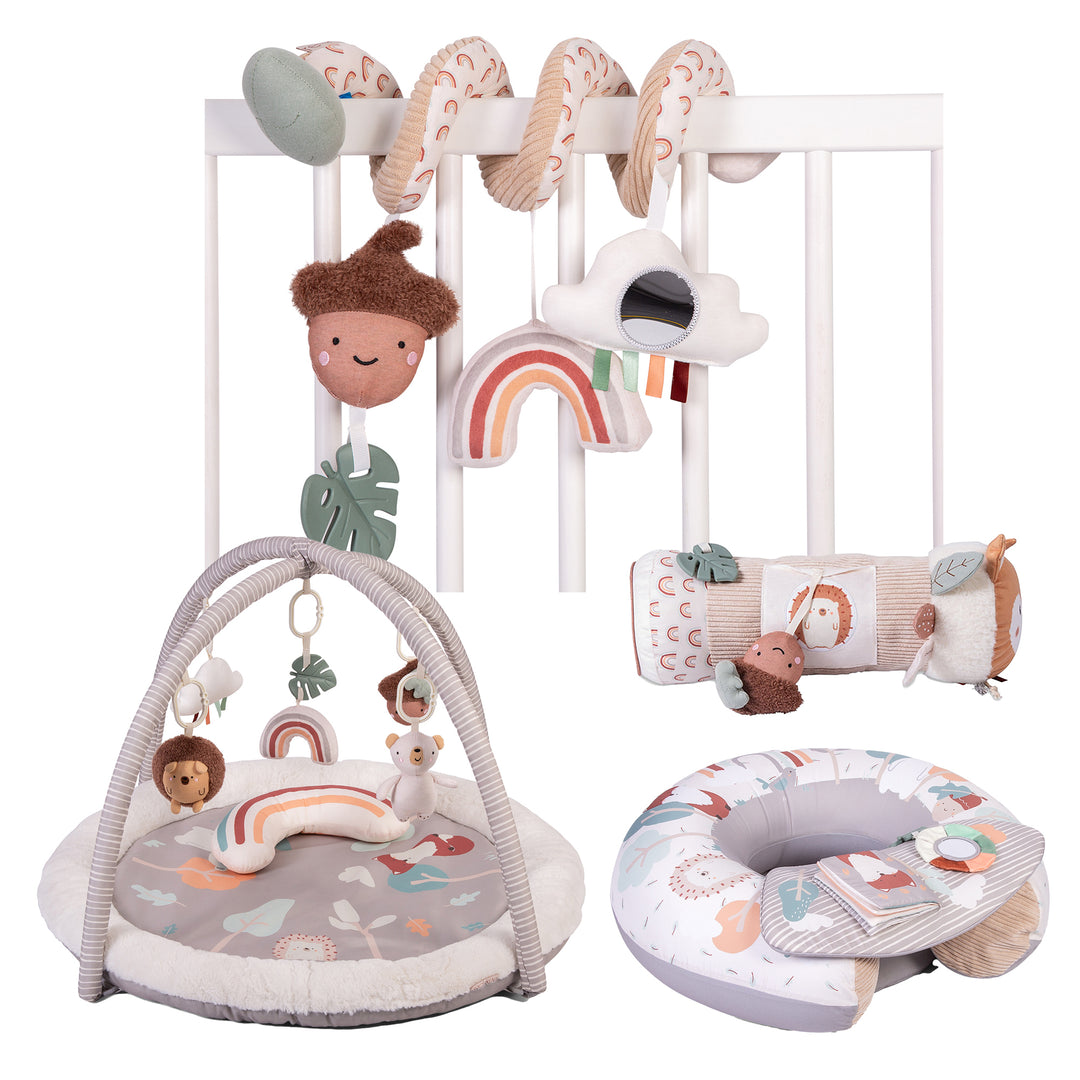 A collection of baby play gym and activity toys including a padded play gym with hanging toys, a sit me up seat with a detachable play tray, a spiral toy with various play activities like mirrors and rattles, and a tummy time roller.