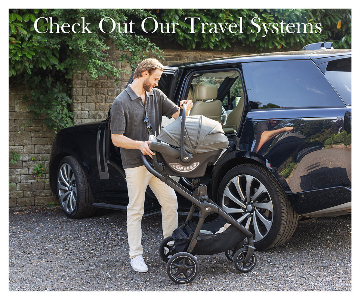 Travel systems banner image with man and baby in garden with car in background