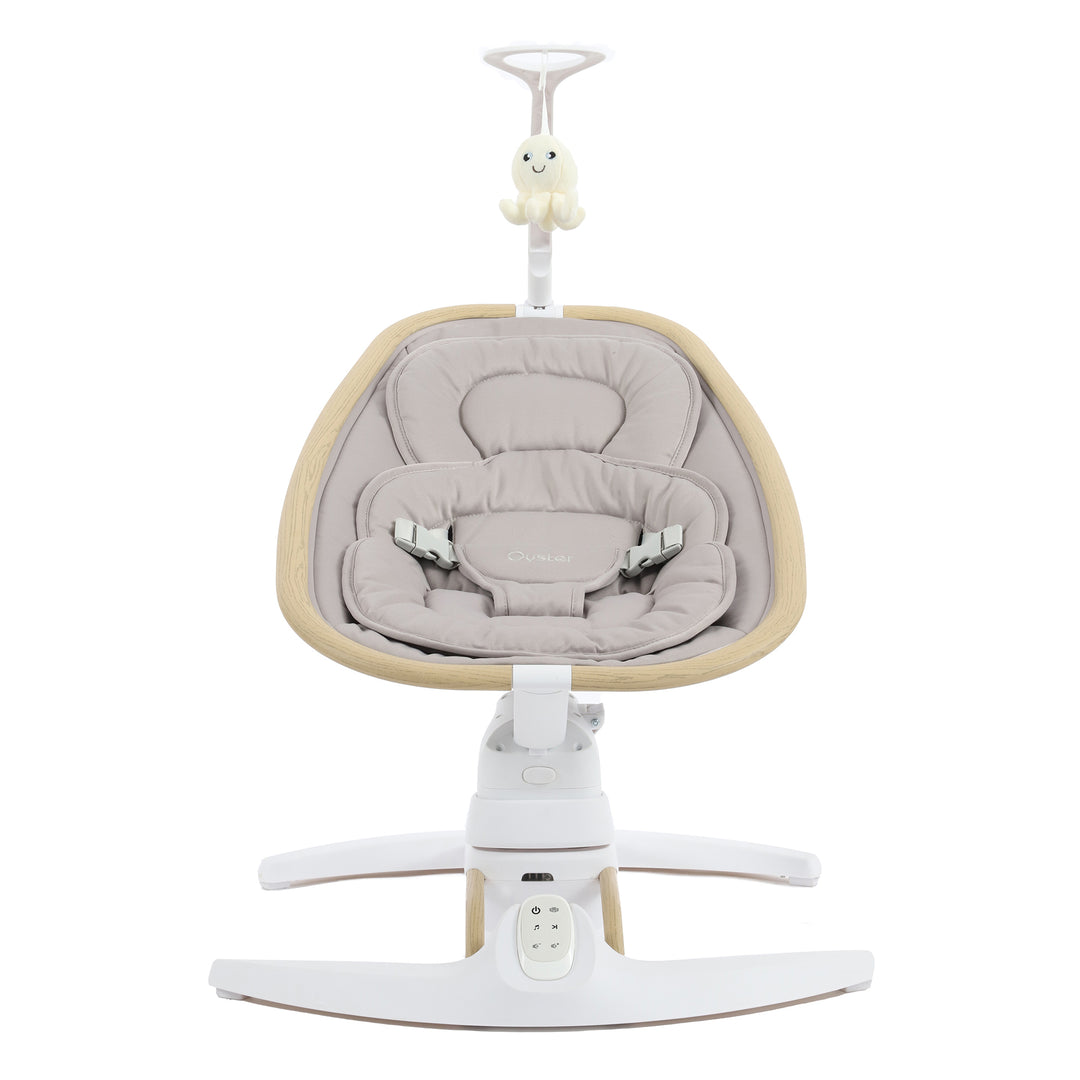 Baby swing with beige cushion and white base on a white background