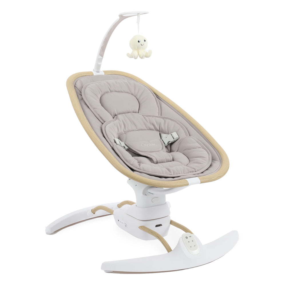Baby swing with beige cushion and white base on a white background