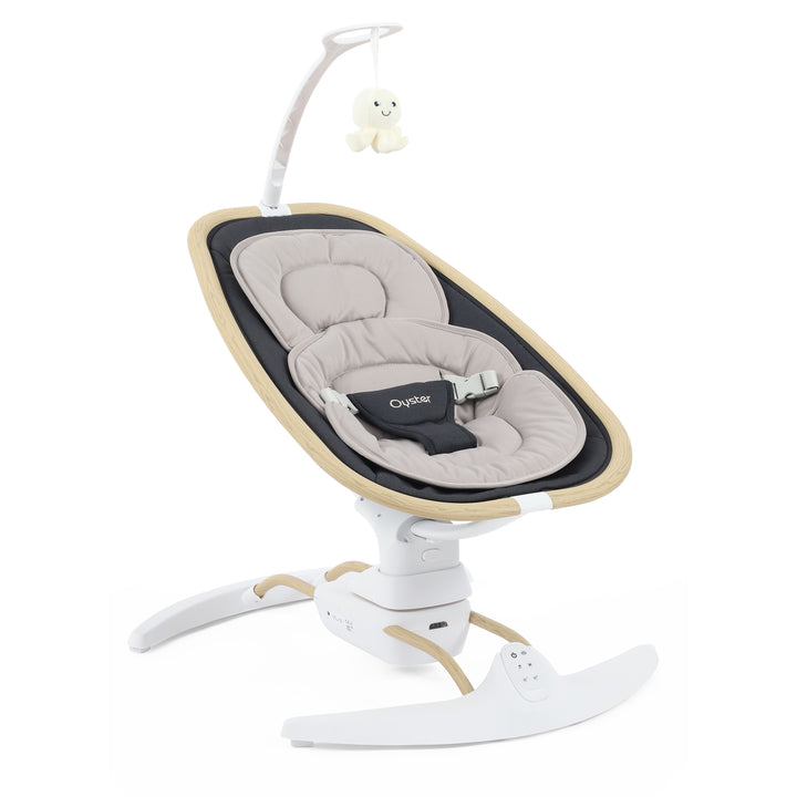 Baby swing with beige seat and white base on a white background