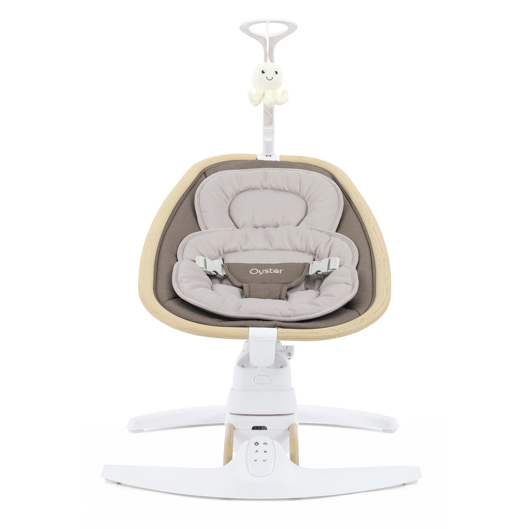Baby swing with beige cushion and white base on a white background