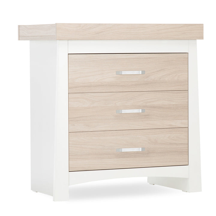 White and light wood nightstand with three drawers on a white background
