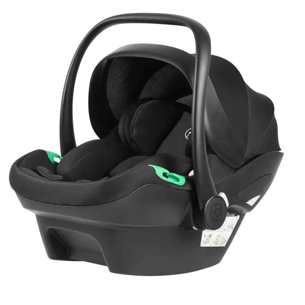 Black baby car seat with green accents on a white background