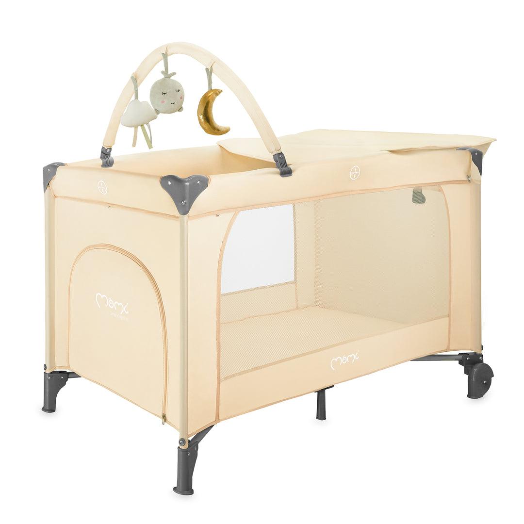 Beige baby playpen with mobile on a white background