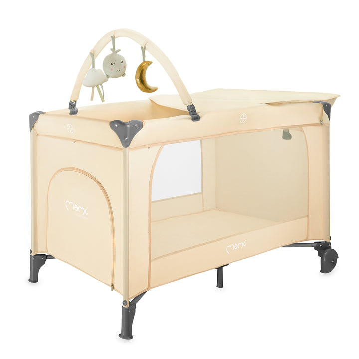 Beige baby playpen with mobile on a white background