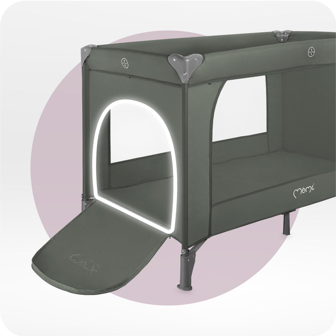 Green baby crib with a white interior on a light purple background