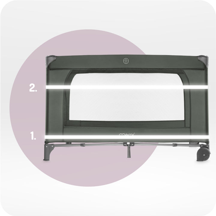 Black crib rail with white padding on a light purple circle background