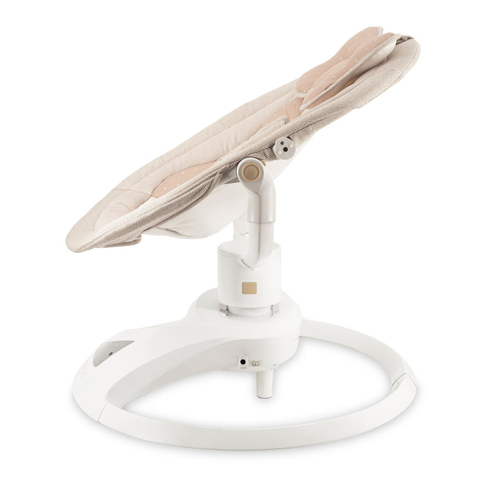 Baby swing with beige seat and white base on a white background