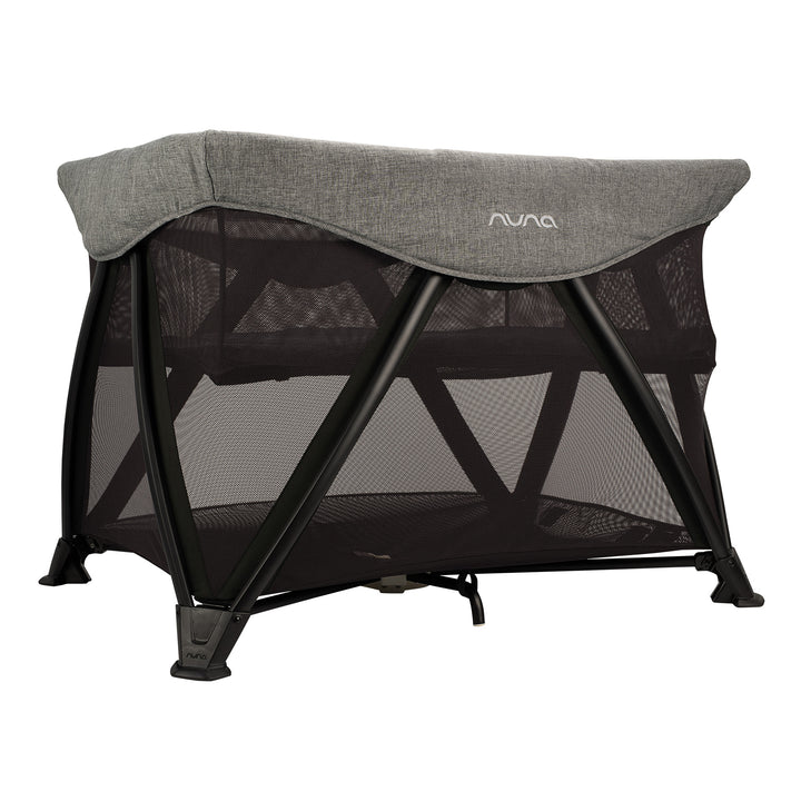 Nuna travel cot with gray canopy on a white background