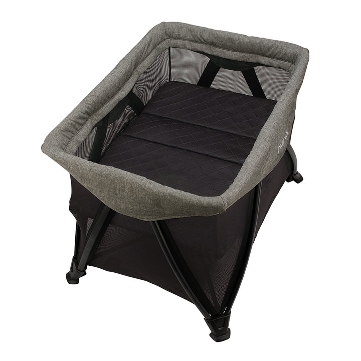 Portable baby bassinet with gray cover and black interior on a white background