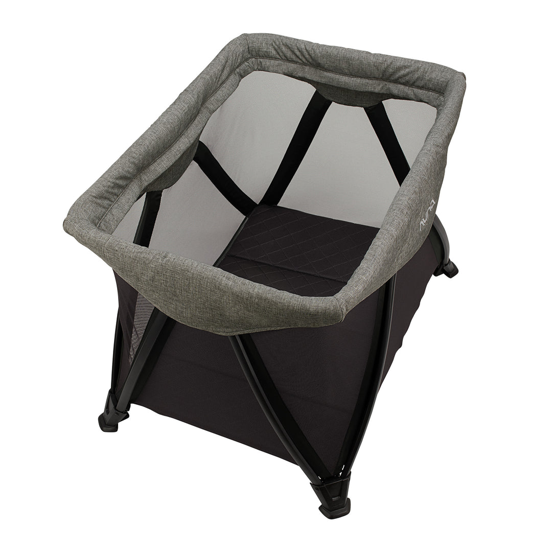 Portable baby bassinet with gray cover and black base on a white background
