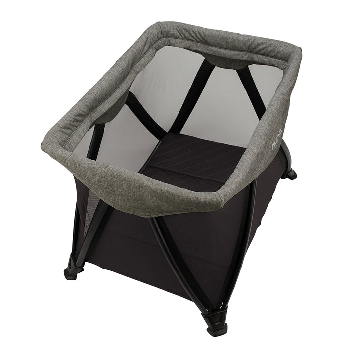 Portable baby bassinet with gray cover and black base on a white background