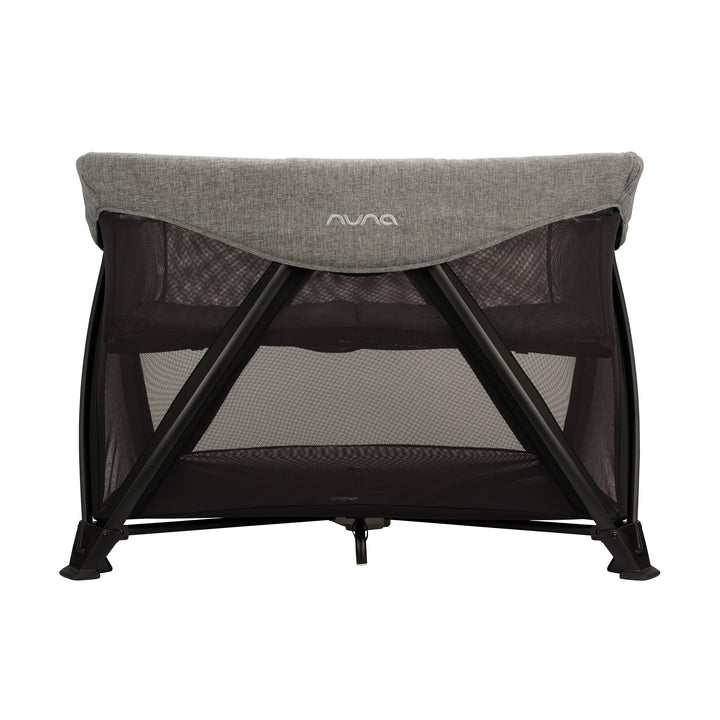 Nuna baby crib with gray mesh and black frame on a white background