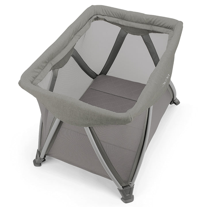 Gray baby crib with mesh side on a white background