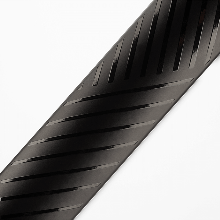 Close-up of a black bicycle tire with tread pattern on a white background