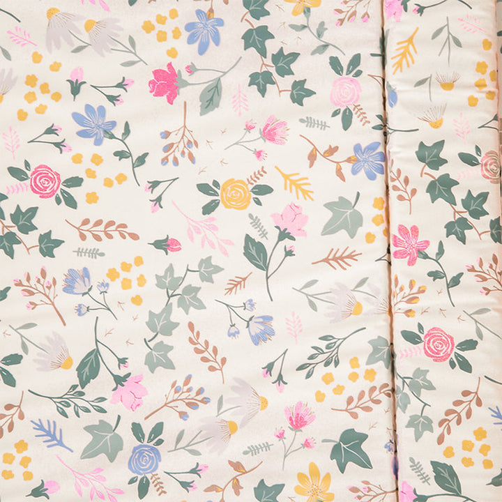 Floral patterned fabric with colorful flowers and leaves on a light background