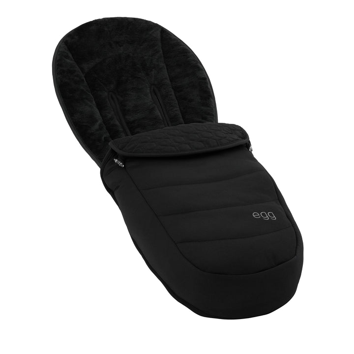 Black baby footmuff with quilted design on a white background